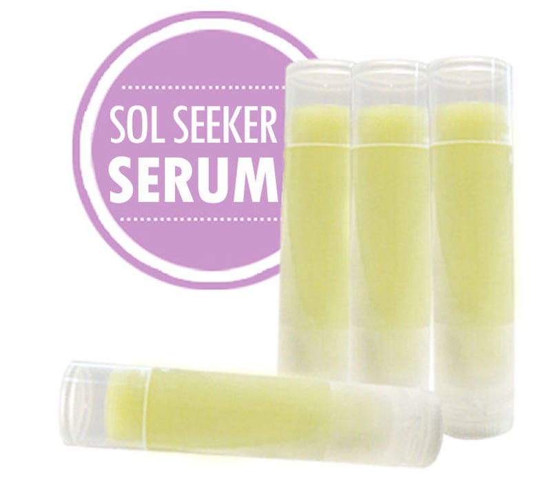 May include: Four clear tubes of yellow lip balm with the text "SOL SEEKER SERUM" on a purple circle.