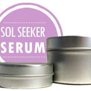 May include: Two silver metal containers with a purple label that reads "SOL SEEKER SERUM".