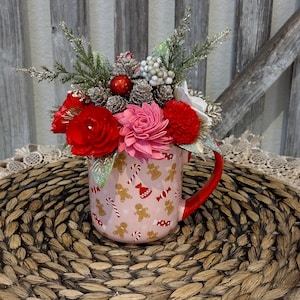 Pink Christmas mug filled with sola wood flowers
