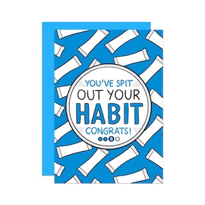 May include: A greeting card with a blue background and a pattern of white objects. The card features a circular design with the text "YOU'VE SPIT OUT YOUR HABIT CONGRATS!" in blue and white.
