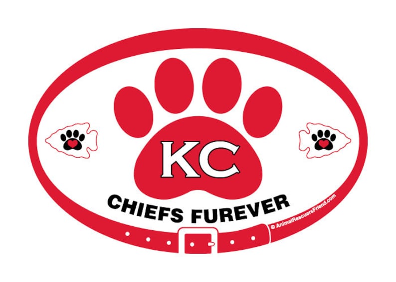 May include: Red, white, and black oval-shaped sticker with a red paw print and the letters "KC" in white. The paw print has a red heart in the center. The text "CHIEFS FUREVER" is below the paw print. The text "AnimalRescuersFriend.com" is in the lower right corner.