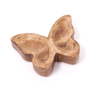 May include: A butterfly-shaped wooden dish featuring a natural brown wood grain finish. The surface of the wings is inlaid with thin, gold-colored metal lines that trace the inner wing patterns, creating a smooth and defined decorative object.