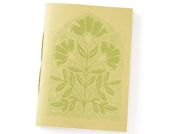 May include: A rectangular notebook with a light yellow cover featuring a centered, dark green botanical illustration of a flowering plant enclosed within an arched frame. The design includes detailed leaves and three blossoms with textured lines.