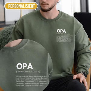 Könnte beinhalten: Olivgrünes Sweatshirt mit dem Wort "OPA" und dem Text "[VON LENI & LUKAS]" in Weiß aufgedruckt. Das Sweatshirt hat einen Rundhalsausschnitt und lange Ärmel. Das Wort "PERSONALISIERT" befindet sich in einem gelben Oval oben links.