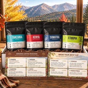 May include: Four black coffee bags labeled Tanzania, Kenya, Sumatra, and Ethiopia, each with a colored label. A printed information card titled Nirvana Coffee Roasters provides brewing ratios and flavor notes for each coffee origin.