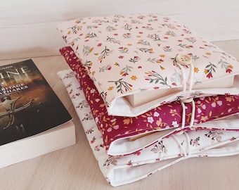 Padded fabric book cover closed with a button, protective book cover with Liberty pattern