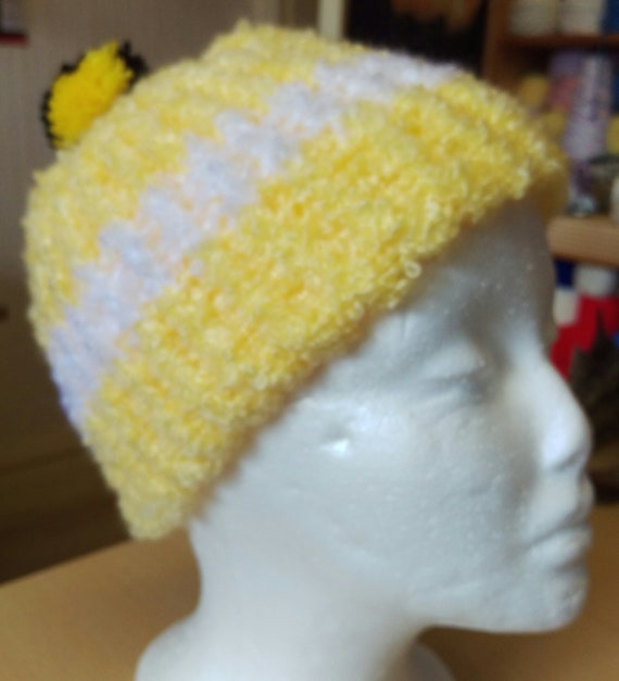 black and yellow bobble hat