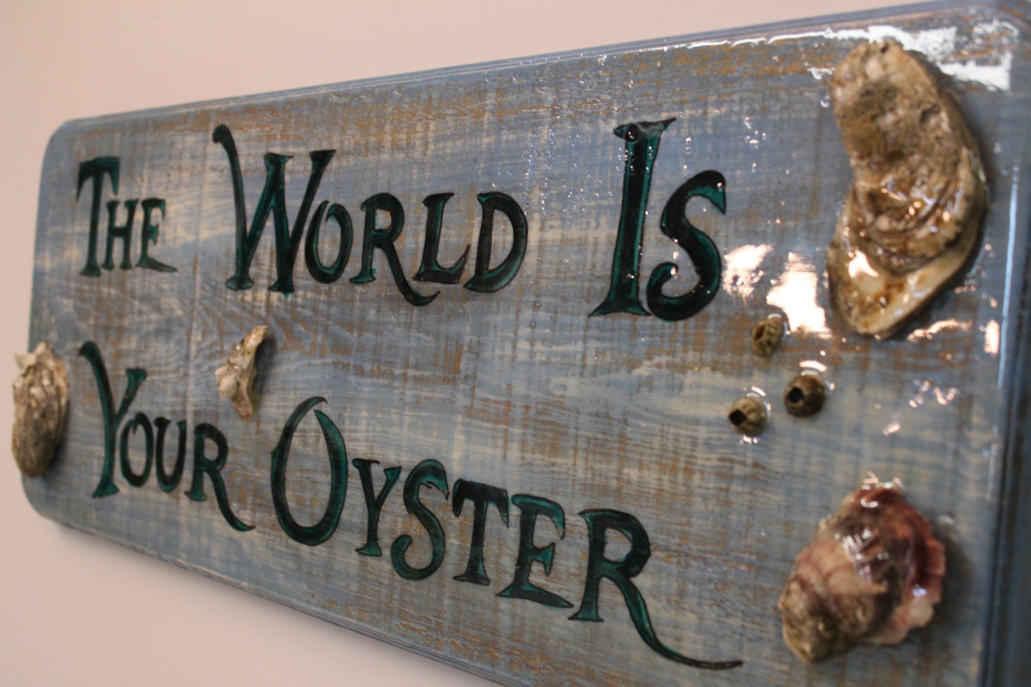 The World Is Your Oyster handpainted sign on distressed cypress wood