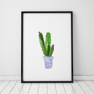 May include: A watercolor painting of a cactus plant in a purple pot. The cactus is green with a few pink and purple flowers.
