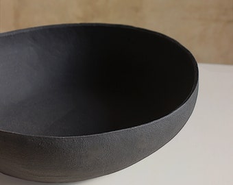 Minimalist centerpiece made of black stoneware, ideal for contemporary decoration and modern architecture. Handmade in italy.