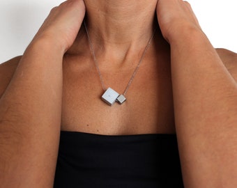 Geometric necklace with 925 silver chain and concrete & stainless steel cubes. Architecture necklace from the concrete jewelry by ORTOGONALE
