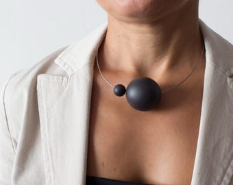 Modern asymmetric necklace URANO made of black porcelain in limited edition.