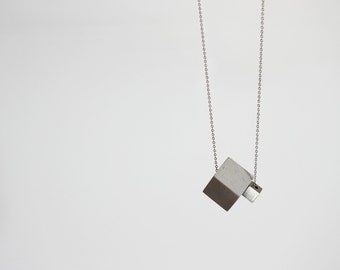 Geometric long necklace 2NX, concrete jewelry with concrete and stainless steel cubes, and italian 925 silver chain. Architecture to wear