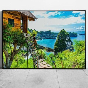 Donna in piedi fuori dalla casa sull'albero, posizione tropicale esotica, acque blu intenso, stampa artistica su carta, stampa con cornice
