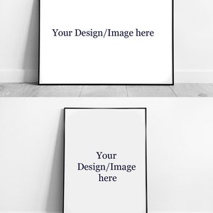 May include: Two black framed art prints with white backgrounds and the text "Your Design/Image here". The prints are leaning against a white wall and a light grey wood floor.