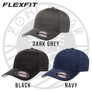 May include: Three Flexfit brand baseball caps in dark grey, black, and navy blue. The caps have a curved brim and a Flexfit logo on the back.