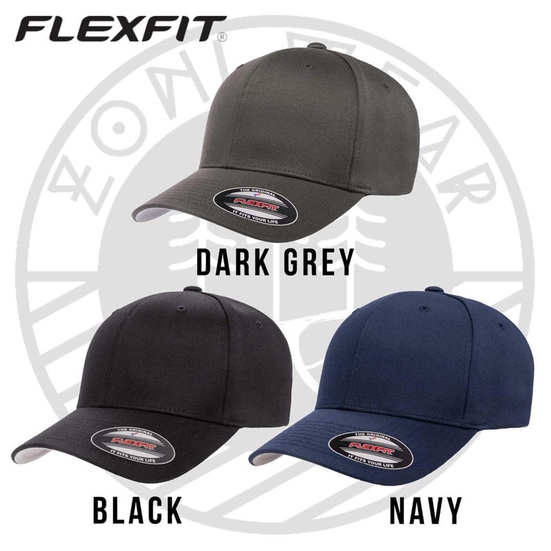 May include: Three Flexfit brand baseball caps in dark grey, black, and navy blue. The caps have a curved brim and a Flexfit logo on the back.