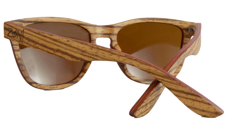 May include: Brown wood sunglasses with red accents and the word "ZONI" engraved on the side.