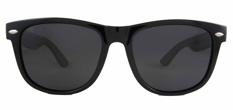 May include: Black sunglasses with a classic square frame and dark lenses.