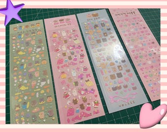 May include: Four sheets of colorful stickers featuring various cute cartoon animals, hearts, and other designs. The stickers are packaged in clear plastic sleeves and are perfect for adding a touch of whimsy to journals, planners, and other craft projects.