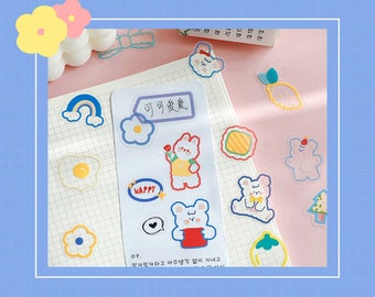 May include: A sheet of colorful stickers featuring cute cartoon bears, flowers, rainbows, and other whimsical designs. The stickers are perfect for adding a touch of personality to journals, planners, and other paper goods.
