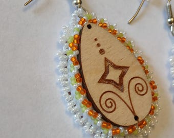 hand beaded and etched star and fiddlehead design wood center earrings