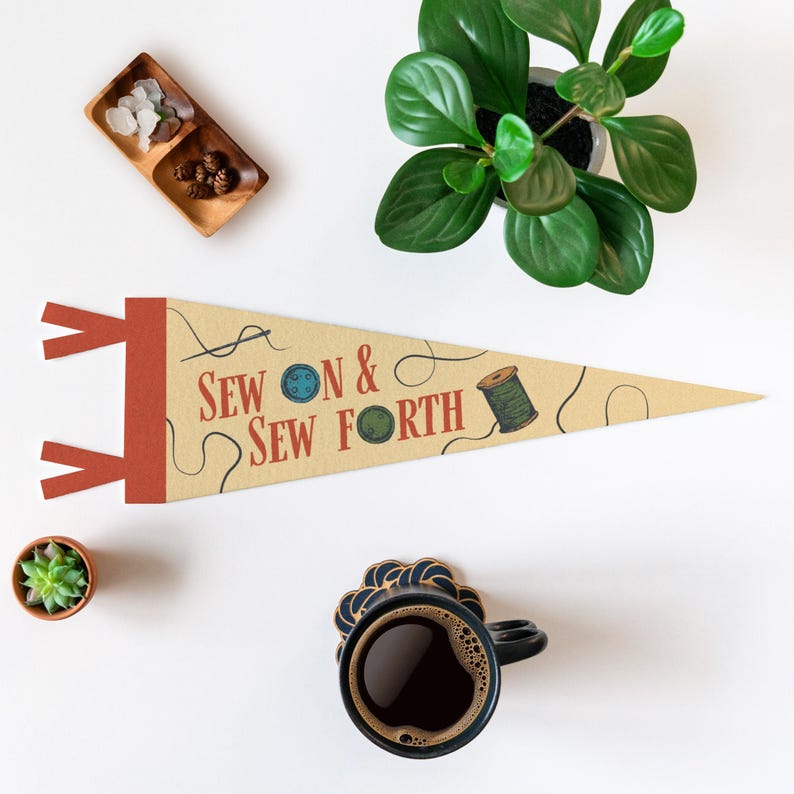 a sewing and sewing-related theme, with a pendant featuring the text "Sew & Sewforth" and a sewing kit, a small potted plant, a cup of coffee, and a small succulent plant.