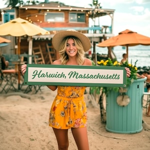 May include: A white ceramic mug with a black handle and the text "But First, Coffee" in a black, handwritten-style font. The mug is on a white surface.