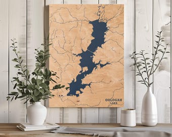 May include: A wooden map of Oologah Lake, Oklahoma, with the lake area highlighted in blue. The map is mounted on a light wood background and has a white border.