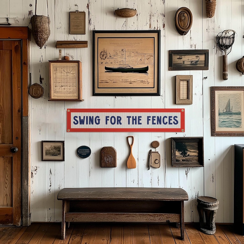 The image is a wall adorned with various framed pictures, a sign, and a bench, creating a rustic and vintage atmosphere.