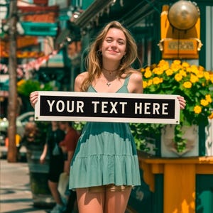 May include: A person holding a black and white sign that reads "YOUR TEXT HERE". The person is wearing a green dress and standing outside on a sunny day. Yellow flowers and other signs are in the background.