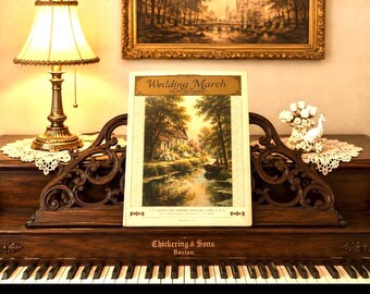 May include: A vintage sheet music cover titled Wedding March by Mendelssohn, featuring a landscape illustration of a house by a river with a boat. The paper is cream-coloured with dark text and is displayed on a dark wood ornate music stand.