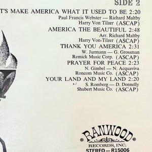 Op de afbeelding: Een witte vinyl platenhoes met zwarte tekst die de nummers van KANT 2 vermeldt: LET'S MAKE AMERICA WHAT IT USED TO BE, AMERICA THE BEAUTIFUL, THANK YOU AMERICA, PRAYER FOR PEACE en YOUR LAND AND MY LAND, met het Ranwood Records logo onderaan.