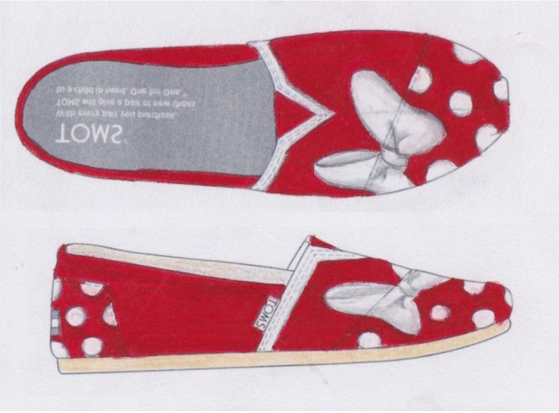 May include: Red canvas slip-on shoes with white polka dots and a white bow design. The shoes have the word "TOMS" printed on the side.