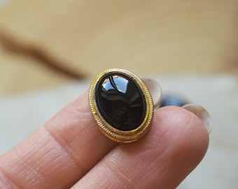 Medium size black onyx cabochon set in brass. Macramé stone with groove