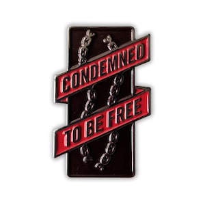 May include: A black and red enamel pin with a chain design and the text "Condemned to be free".