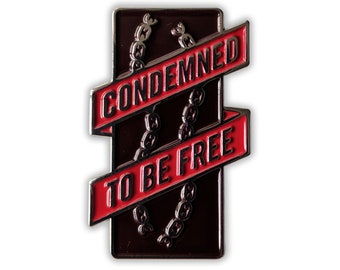 May include: A black and red enamel pin with a chain design and the text "Condemned to be free".