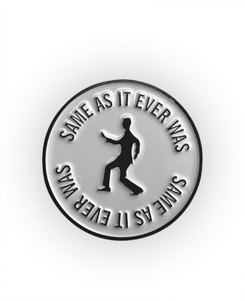 May include: White enamel pin with a black silhouette of a person dancing and the text "Same As It Ever Was" repeated around the edge.