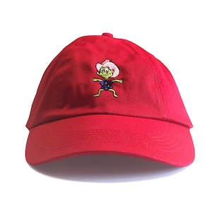 May include: Red baseball cap with an embroidered cartoon character wearing a cowboy hat. The character is green with a blue shirt and brown boots.