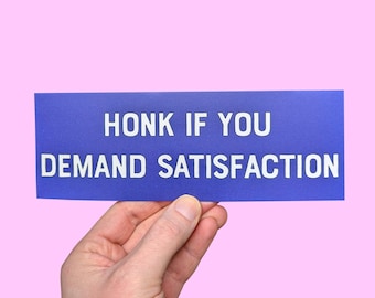 May include: A blue sign with white text that reads "Honk if you demand satisfaction".