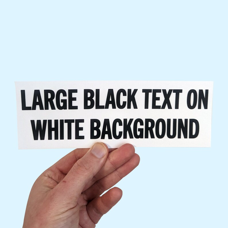 May include: A white card with the text "LARGE BLACK TEXT ON WHITE BACKGROUND" printed in black.