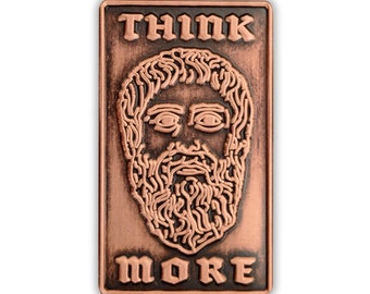 May include: A copper-colored metal pin with a stylized image of a bearded man's face and the text "THINK MORE" in a gothic font.