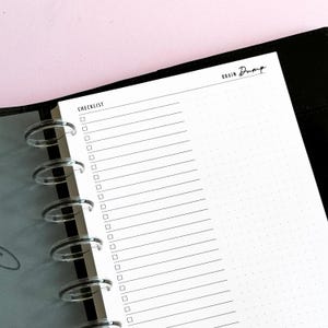 May include: A white paper planner insert featuring a checklist section with horizontal lines and square checkboxes on the left, and a dot grid section on the right. The top of the page is labeled with the text CHECKLIST and BRAIN DUMP.