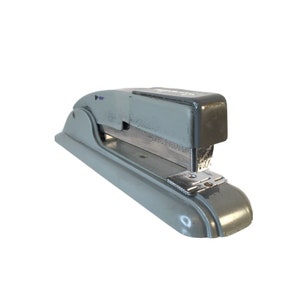 May include: A gray metal stapler with a silver staple remover. The stapler has a black top and a silver metal staple guide.