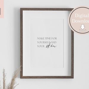 May include: A printable wall art print with a brown wood frame. The print features the text "Make time for yourself and your skin" in black cursive font.