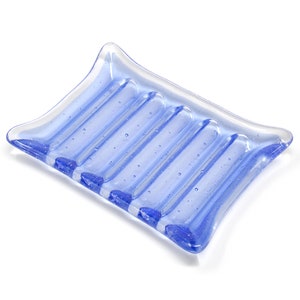 May include: A light blue glass soap dish with five ridges and a textured surface.