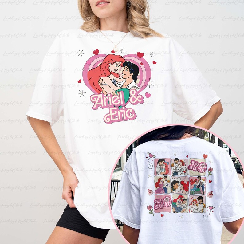 May include: White t-shirt featuring a pink heart design with Ariel and Eric embracing, surrounded by hearts and stars. The text "Ariel & Eric" is below the image. The back of the shirt has a collage of Ariel and Eric images.