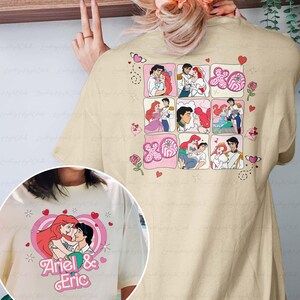 May include: Beige t-shirt featuring a graphic of Ariel and Eric from The Little Mermaid. The front graphic shows the couple in a heart-shaped design with the text "Ariel & Eric." The back of the shirt has a grid of images of the couple with hearts and roses.