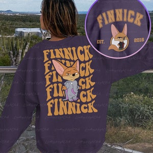 May include: Purple sweatshirt with a cartoon fox wearing pajamas and the text "FINNICK EST. 2016" on the front. The text "FINNICK" is repeated multiple times in a retro font on the back.