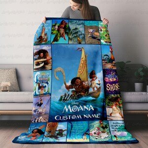 a woman is holding a blanket with a picture of moan